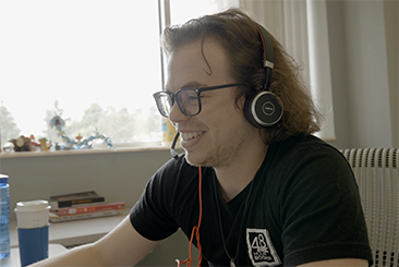 Customer Service Rep Giving Free Book Printing Advice on the Phone Using a Headset