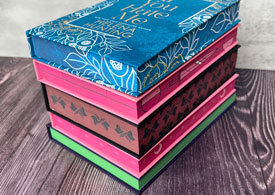 4 books stacked with printed edges