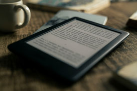 eReader on table with coffee cup 